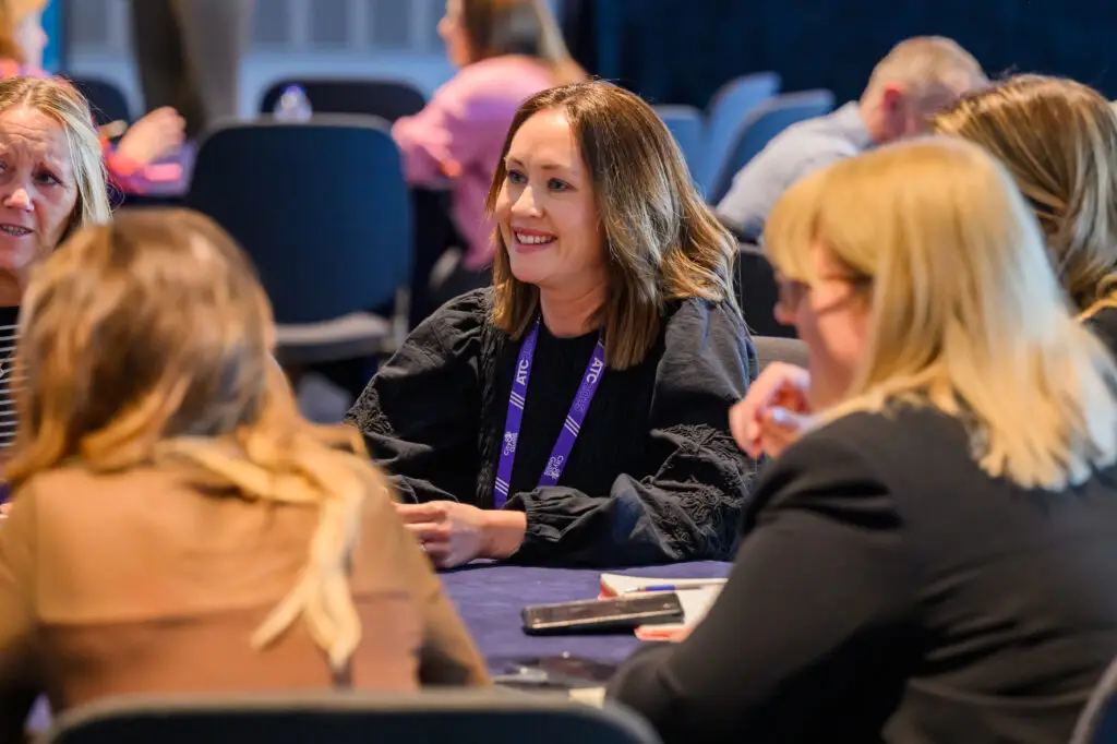 Smiling attendee at atc 2025 in a workshop
